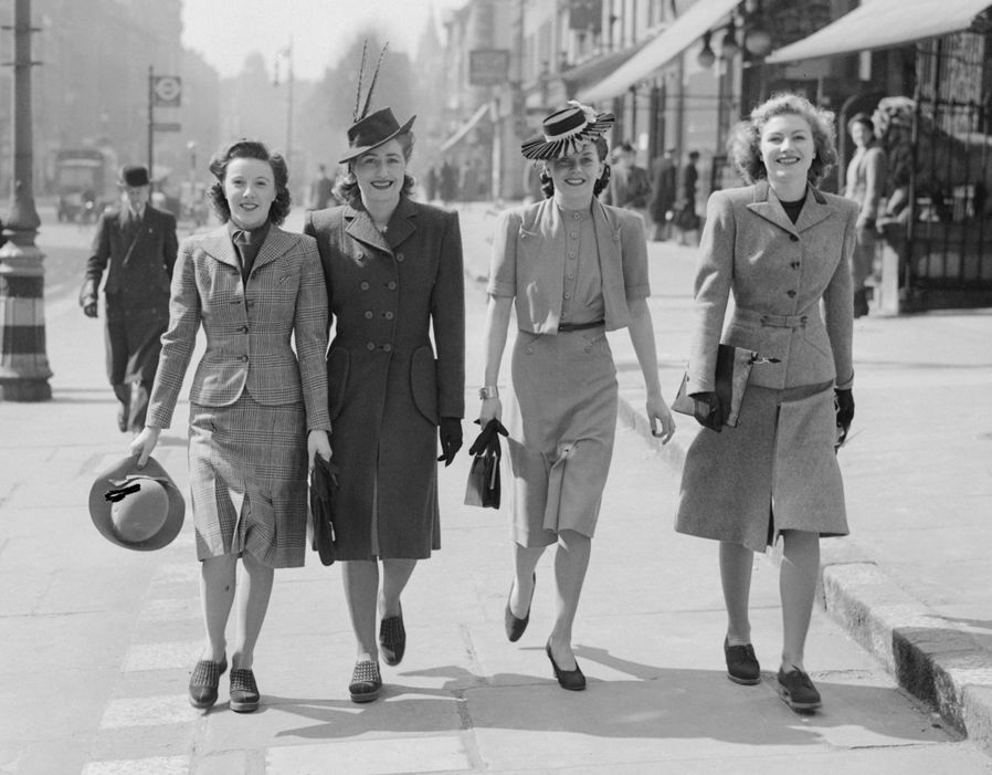 Four women photographed on a London street wearing 1940s wartime clothing